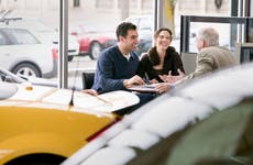 Couple negotiates at an auto dealership