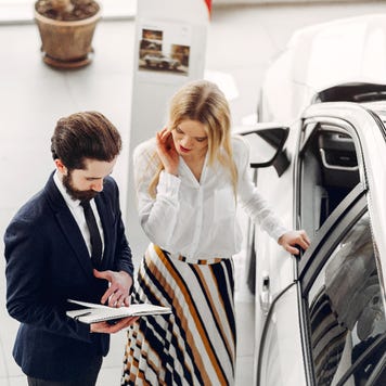 A salesperson and a customer discuss a car