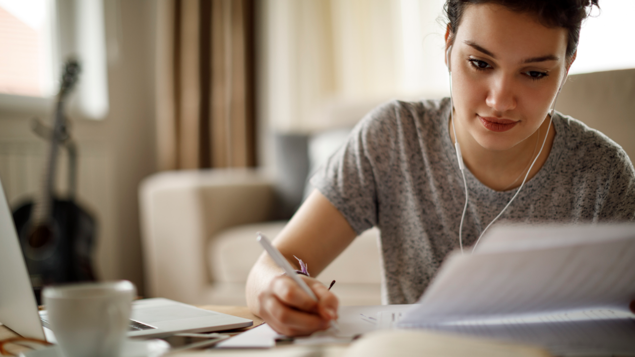 Woman at a desk writing financial payment plan