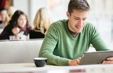 Man looking at loan on tablet