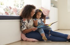 Mother reads to her young daugher