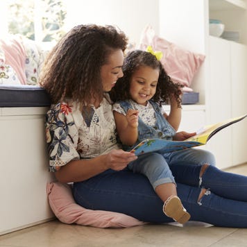 Mother reads to her young daugher