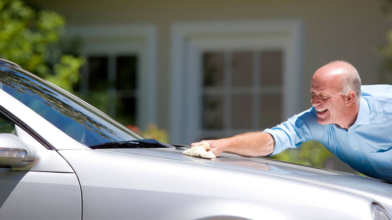 Man waxing car