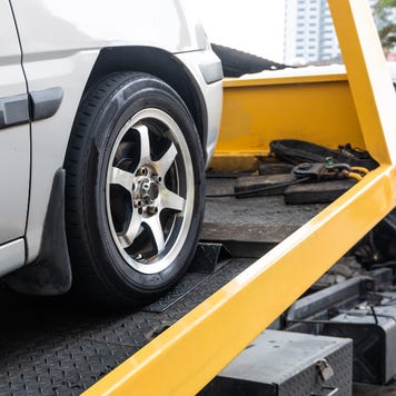 Close up of silver car on tow truck bed