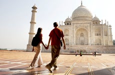 Young couple walking in the Taj Mahal courtyard