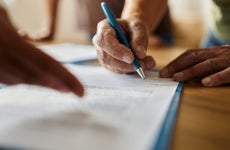 Close up of a person signing a contract