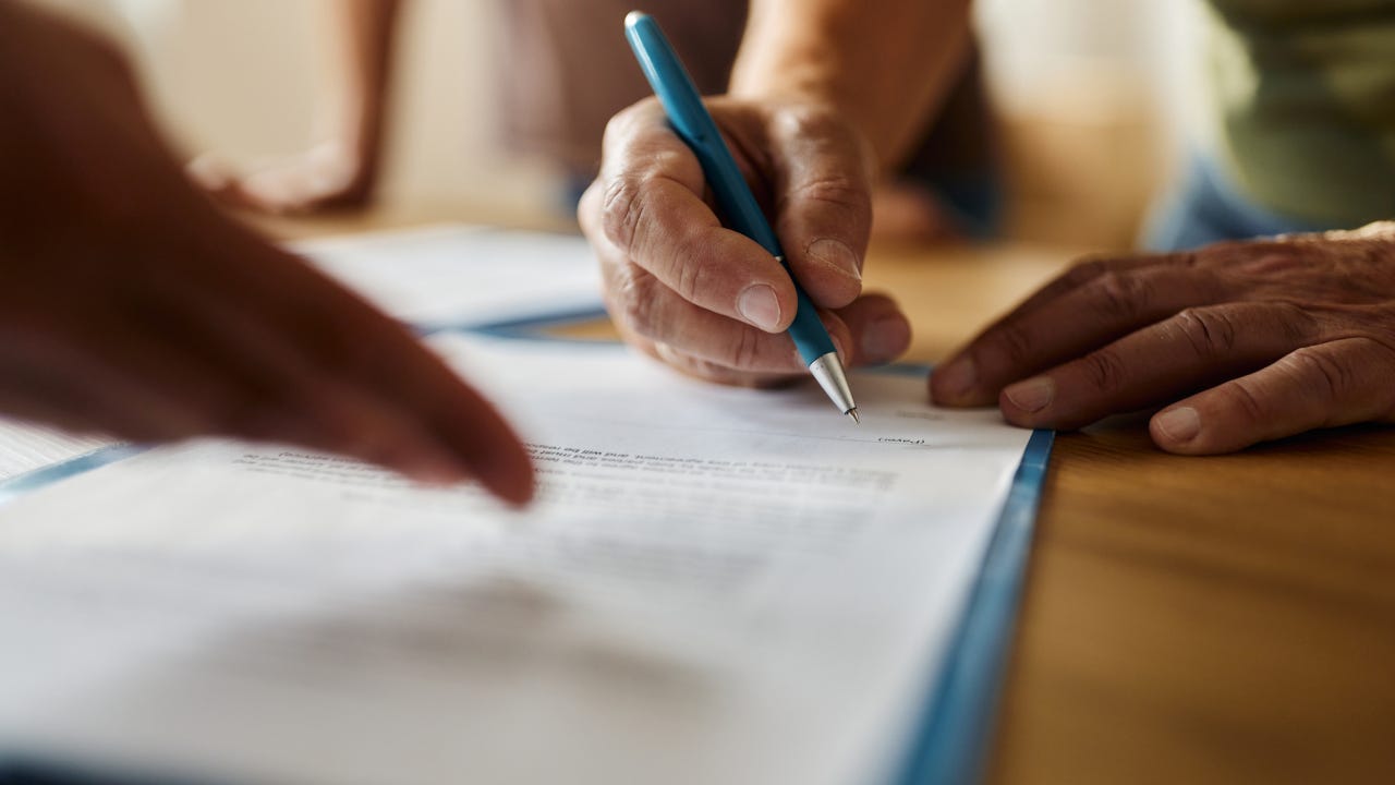 Close up of a person signing a contract