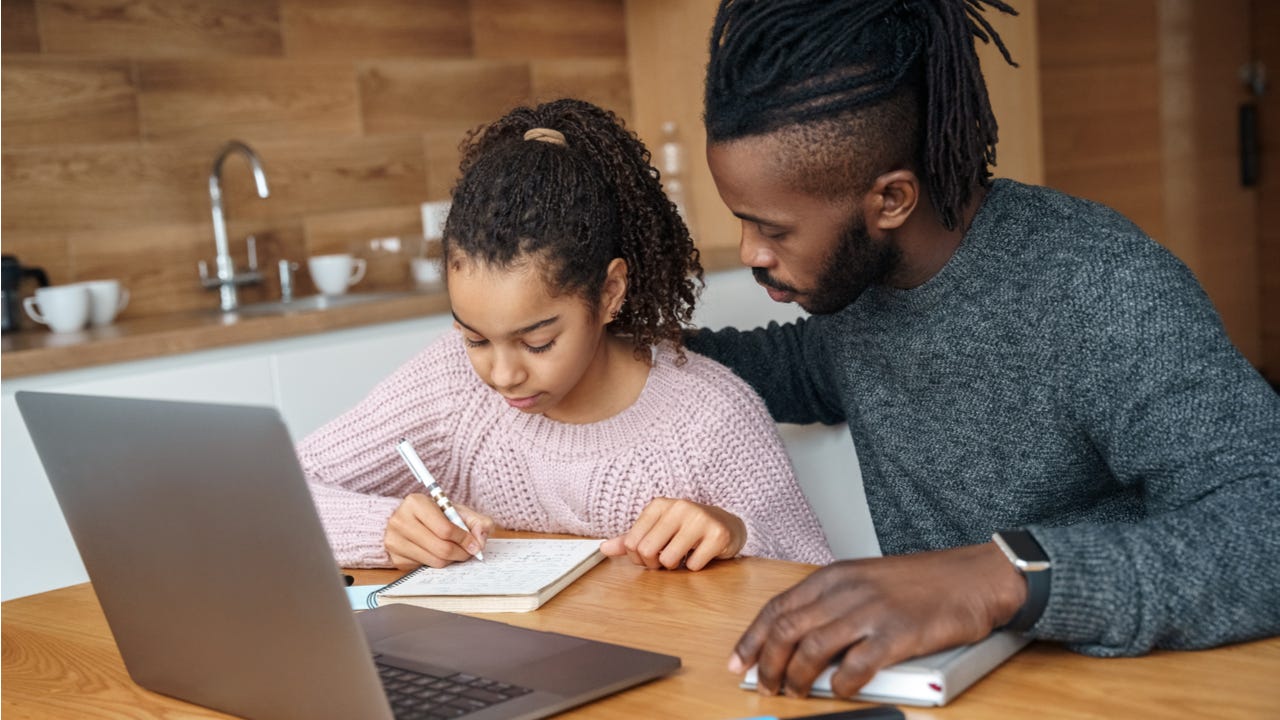 Father helps daughter with homework