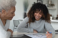 An African American Adviser Meets with A Senior Client