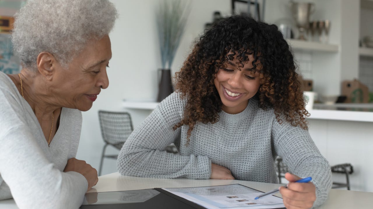 An African American Adviser Meets with A Senior Client