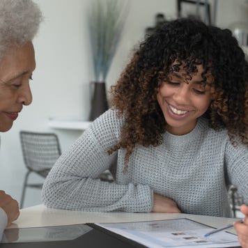 An African American Adviser Meets with A Senior Client