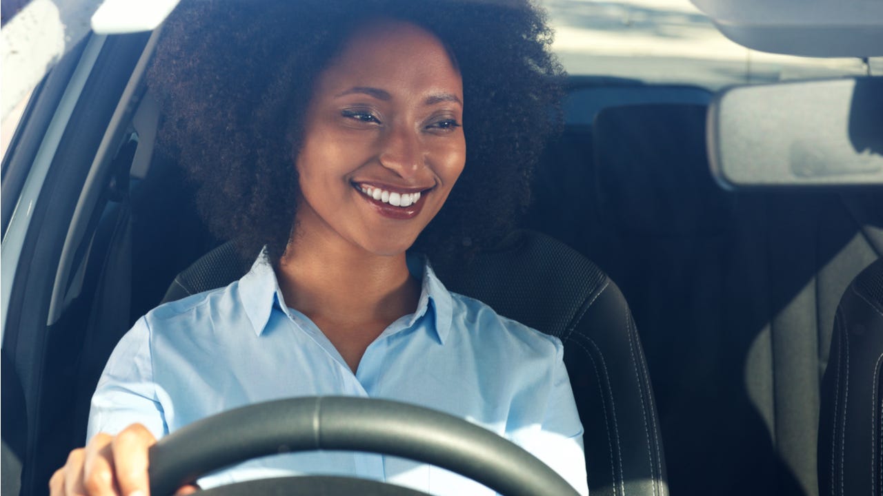 Woman smiles while driving a car