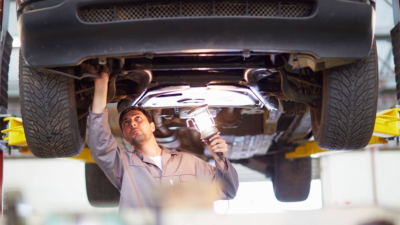Auto mechanic inspecting a car