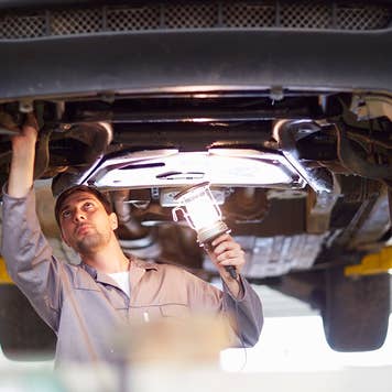 Auto mechanic inspecting a car