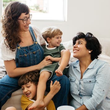 Two moms play with children