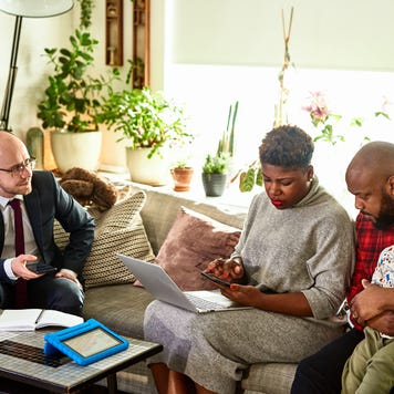 A couple and their child review their finances with a consultant.