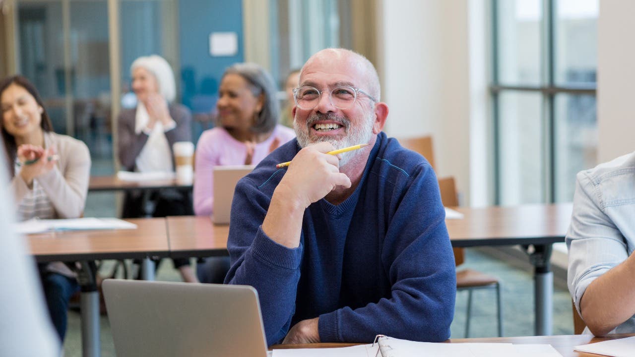 Adult student listens in a college class