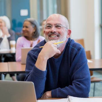 Adult student listens in a college class