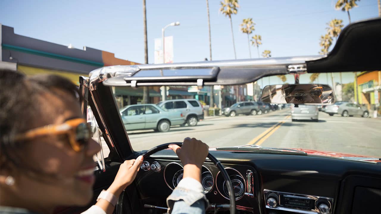 Woman driving a convertible with the top down