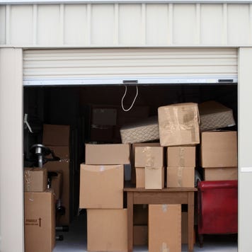A storage unit full of cardboard boxes.