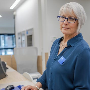 bank teller working at computer in bank branch
