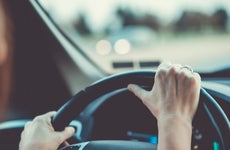 Close up of woman's hands on steering wheel