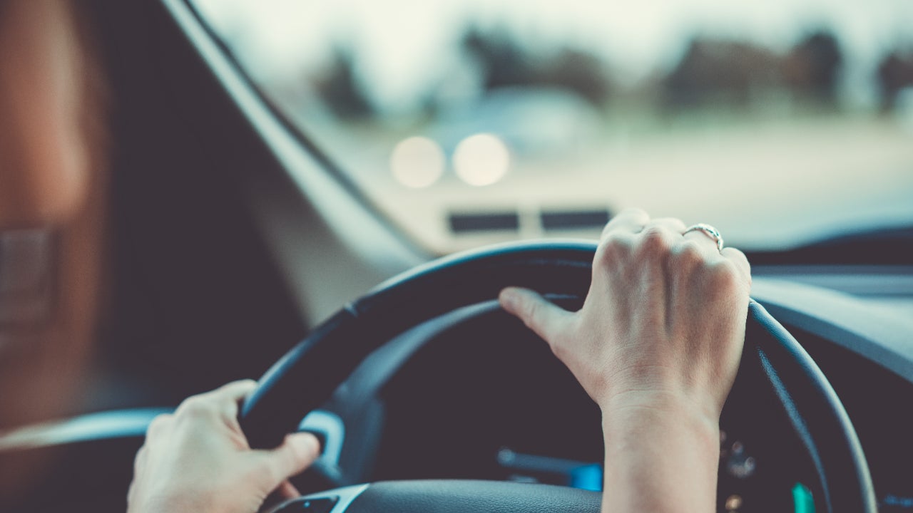 Close up of woman's hands on steering wheel