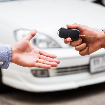 One person hands keys to another.