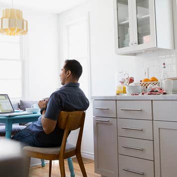 Consumer investigating unclaimed life insurance from his kitchen