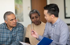 An older couple sits down with a consultant to talk about their policy.