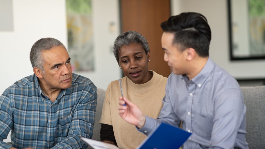 An older couple sits down with a consultant to talk about their policy.