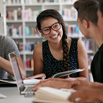 Group of students studies together at the library