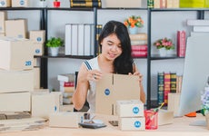 Woman packages orders for her small business