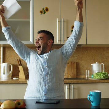 Man opens letter with good news and celebrates
