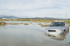 Silver sedan caught in flooded field