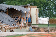 A house in shambles from a sinkhole.