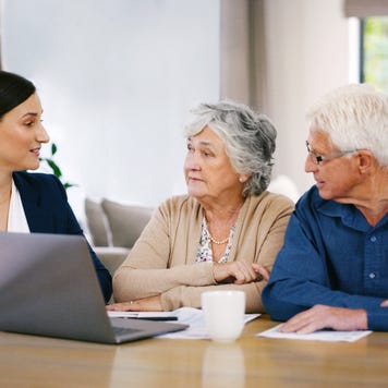 An older couple sits with a young woman who is a financial specialist. She is reviewing their options.