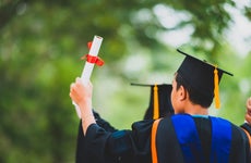 College student raising diploma