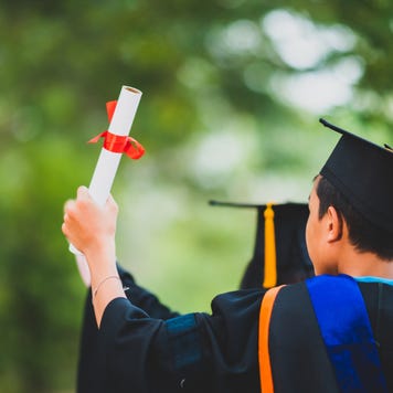 College student raising diploma