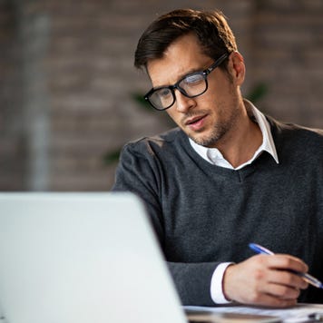 Man works with finances at computer