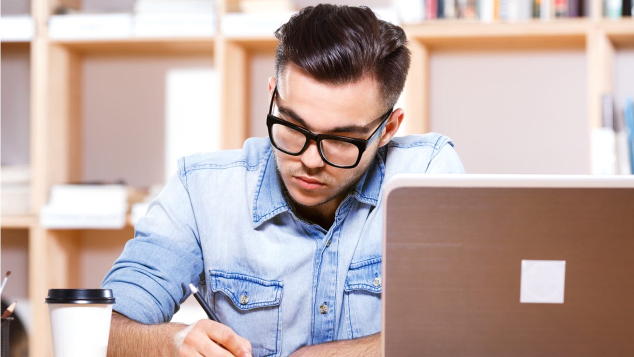 Young man works on paying bills