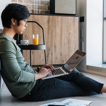 Man checks finances on laptop