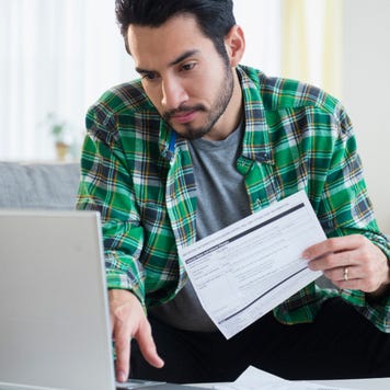 A man looks over bills.