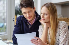 Two people look over financial documents together
