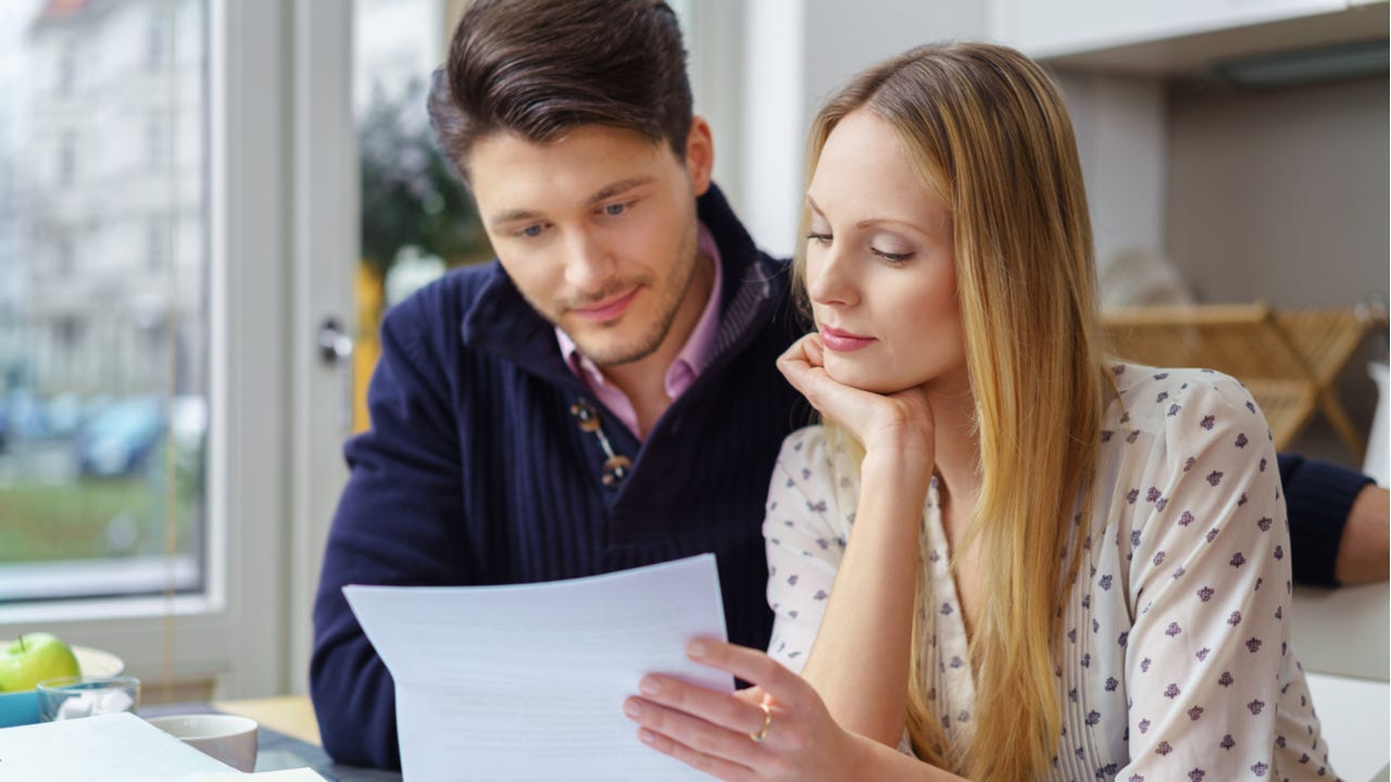 Two people look over financial documents together