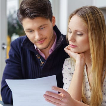 Two people look over financial documents together