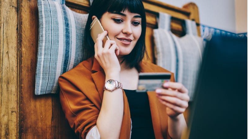 Young woman making credit card purchase over the phone