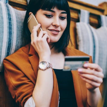 Young woman making credit card purchase over the phone