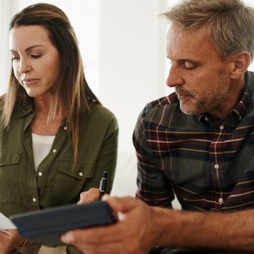 Shot of a mature couple managing their budget together at home
