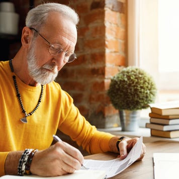 Man makes notes on a financial document
